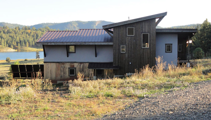 passive solar home with solar hot water collectors in the background