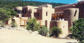 solar adobe home blending into landscape